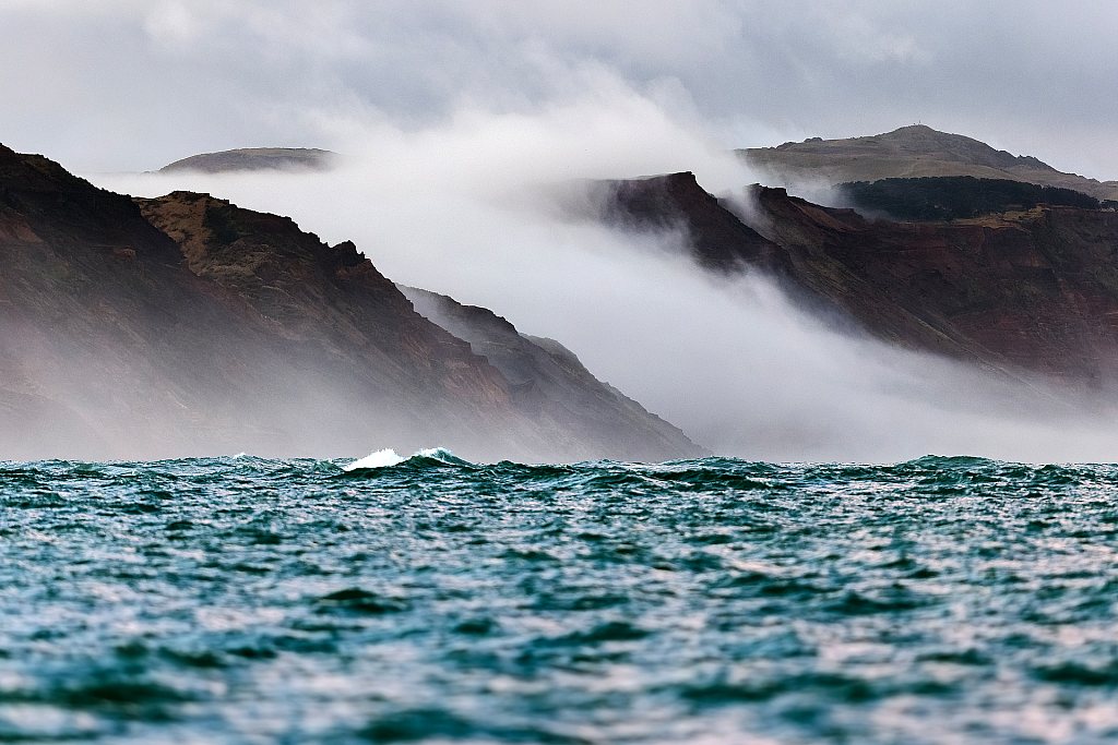 Sea mist over coastal cliffs